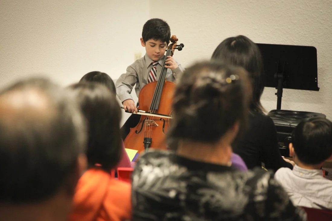 Young cello student after 8 lessons